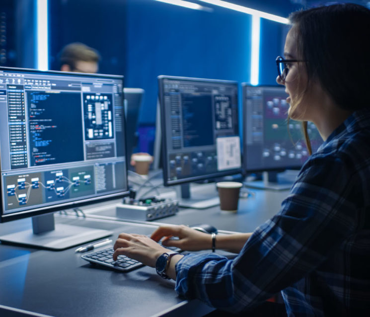 Smart Female IT Programer Working on Desktop Computer in Data Ce